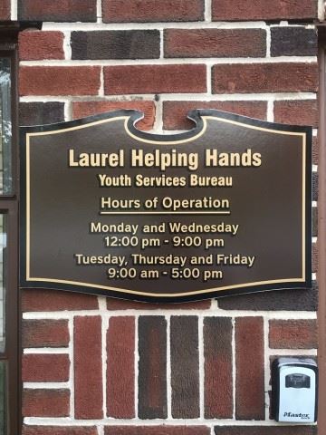 Laurel Helping Hands Placard Shwing the Hours of Operation