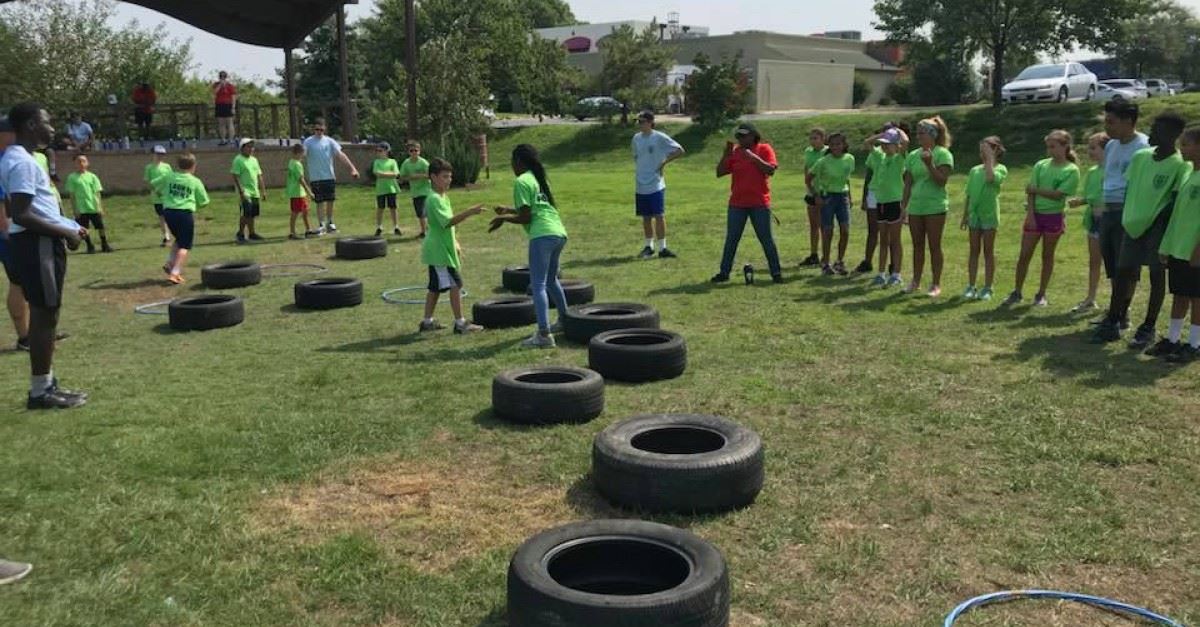 People In a Field with Tires